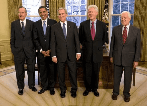 An image of previous US Presidents standing in the oval office